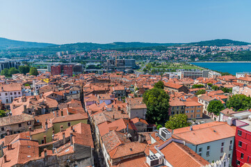 Fototapeta na wymiar A view west from the clock tower above Tito Square over the rooftops of Koper, Slovenia in summertime