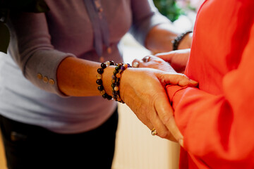 Old ladies holding hands as sign of friendship and closeness 