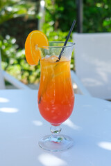 glass of orange juice on the beach