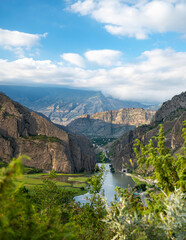 Obraz na płótnie Canvas Beautiful landscape with mountains, valley and a river on a sunny summer day with clouds. Dagestan