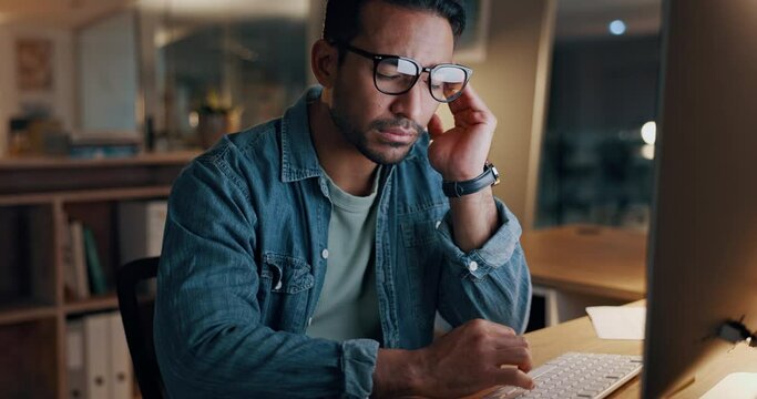 Night, business and man tired, burnout and tension with a deadline, exhausted or overworked in a workplace. Person, dark or employee with fatigue, stress or workaholic with journalist or professional