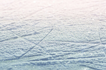 Winter background. Skate marks on ice. Texture blue ice surface with scratches of skates