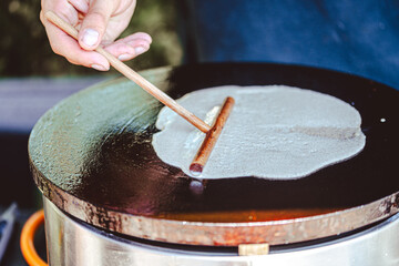 breton galette. buckwheat crepe. making buckwheat pancakes. - obrazy, fototapety, plakaty