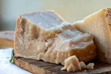 Traditional italian food - 36 months aged in caves Italian parmesan hard cheese from Parmigiano-Reggiano, Italy © barmalini