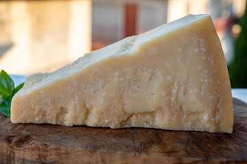 Traditional italian food - 36 months aged in caves Italian parmesan hard cheese from Parmigiano-Reggiano, Italy