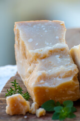 Traditional italian food - 36 months aged in caves Italian parmesan hard cheese from Parmigiano-Reggiano, Italy