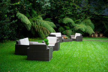 Plastic room installed in outdoor garden, ornamental detail in space covered by grass and old trees. - 642218680