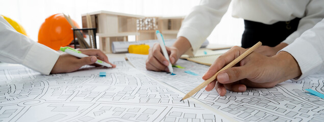 Worker, architect and engineer work on real estate construction project oratory planning with...