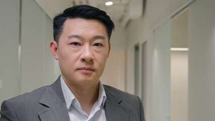 Portrait Asian businessman serious middle-aged ethnic man entrepreneur in office company male mature corporate agent employer looking at camera executive manager business ceo worker lawyer in hallway