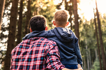 Father and son outdoors enjoying time together in nature	
