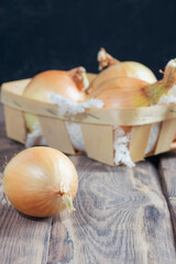 Brown onions .Fresh Raw Bulb Onions. Healthy food background. Ripe onions in a box. orange onion autumn background.