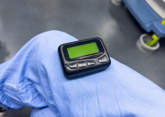 medical communication: A hospital pager signifies instant connection, urgency, and teamwork in...