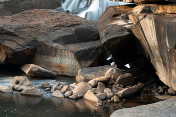 Maak Ngaew Waterfall rock pool,above cascades and rain forest, at sunset, near Pakse,Laos.