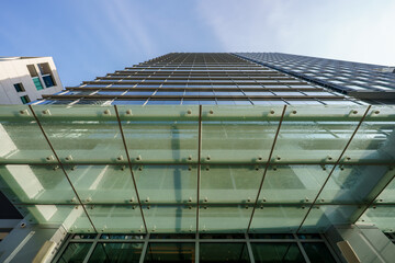 Low angle office building with glass overhand metal frame support