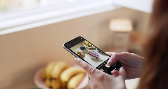 Hand, phone and picture of breakfast with an influencer in her home closeup for a social media post. Food, kitchen and a nutritionist content creator taking a photograph of her healthy morning meal