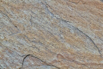 Mountain rock texture. Natural brown slate granite slab marble stone ceramic seamless tile rough surface background. Architecture grunge modern abstract style element. Close-up, copy space