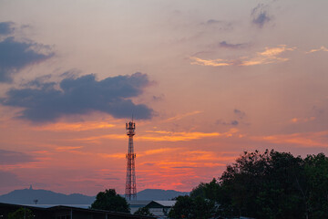 Obraz premium Amazing sky at sunset. Gradient color. Sky texture, abstract nature background..Sunset with red color light rays and other atmospheric effects..Big sunset and sweet lighting sky. phone antenna post.
