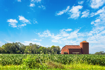 Old red barn and beautiful blue sky with clouds