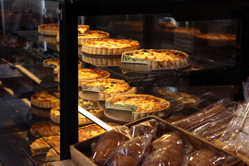 Counter with different tasty pastries in bakery shop