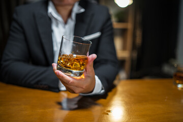Obraz na płótnie Canvas Barman pouring whiskey whiskey glass beautiful night