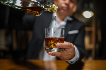 Barman pouring whiskey whiskey glass beautiful night