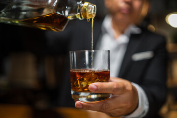 Businessmen in suits drinking whiskey