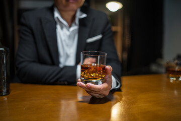 Businessmen in suits drinking whiskey