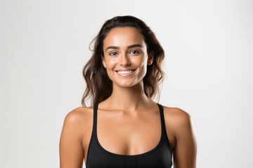Fototapeta premium Portrait of a smiling sportswoman in black sportswear isolated on a white background and Looking at the camera.