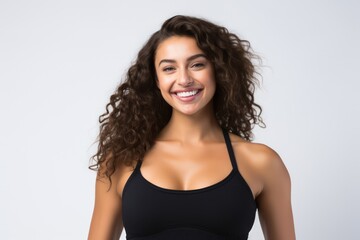 Fototapeta premium Portrait of a smiling sportswoman in black sportswear isolated on a white background and Looking at the camera.