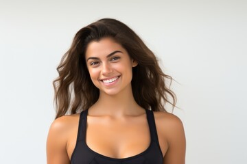 Fototapeta premium Portrait of a smiling sportswoman in black sportswear isolated on a white background and Looking at the camera.
