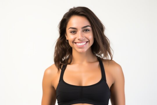 Portrait of a smiling sportswoman in black sportswear isolated on a white background and Looking at the camera.