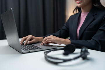 Competent businesswoman working with laptop computer recording data check documents while talking to customers online concept of a call center and customer service office