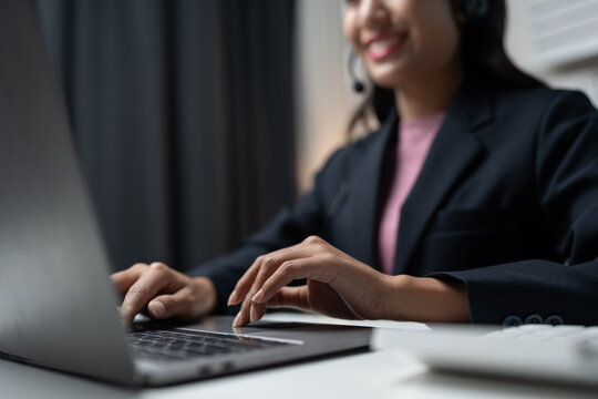 Asia call center with headset and microphone working on laptop Female entrepreneurs serving customers, business information, inquiries Support call center representatives help customers.