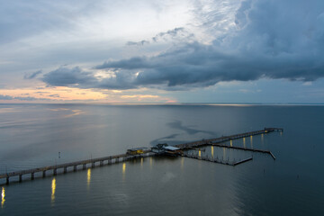 Fototapeta premium Aerial view of the Fairhope Pier at sunset