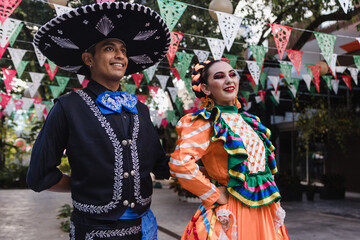 Latin couple of dancers wearing traditional Mexican dress from Guadalajara Jalisco Mexico Latin America, young hispanic woman and man in independence day or cinco de mayo parade or cultural Festival