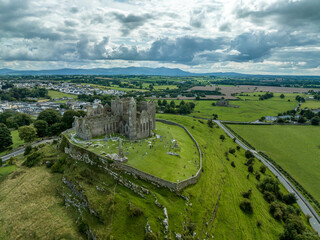 Fototapeta na wymiar Aerial view of Rock of Cashel iconic Irish historic landmark with Romanesque chapel, a Gothic cathedral, an abbey, the Hall of the Vicars Choral and a fifteenth-century Tower House