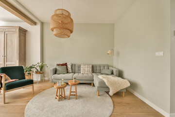 a living room with a couch, chair and coffee table in front of the sofa is an area rug that has...