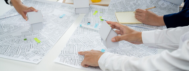 Worker, architect and engineer work on real estate construction project oratory planning with...