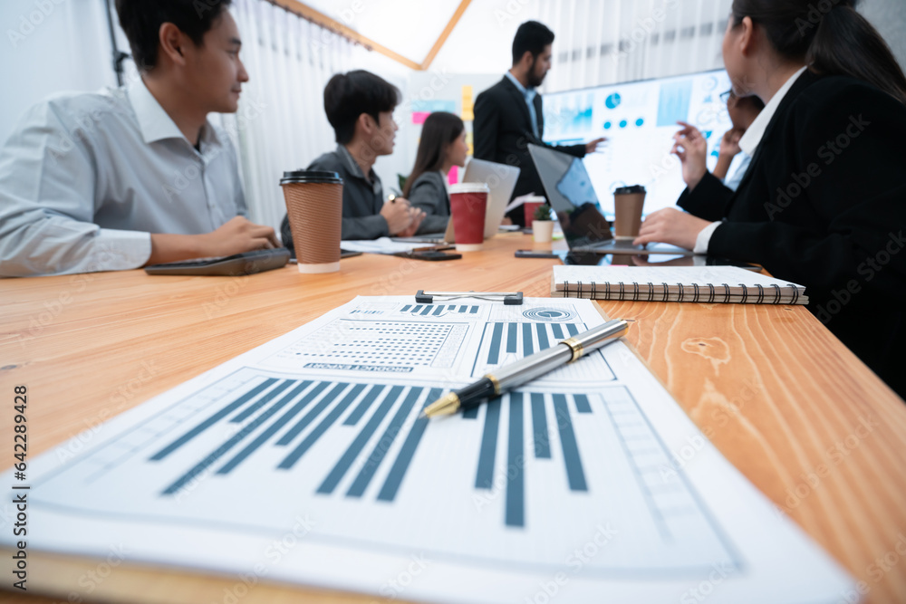 Poster focus financial dashboard paper showing graphs and chart with blurred background of diverse business
