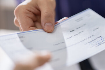 Businessperson Hands Giving Cheque