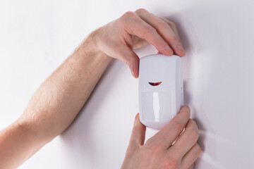 Electrician Installing Security System Door Sensor