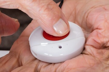 Senior Woman Pressing Alarm Button