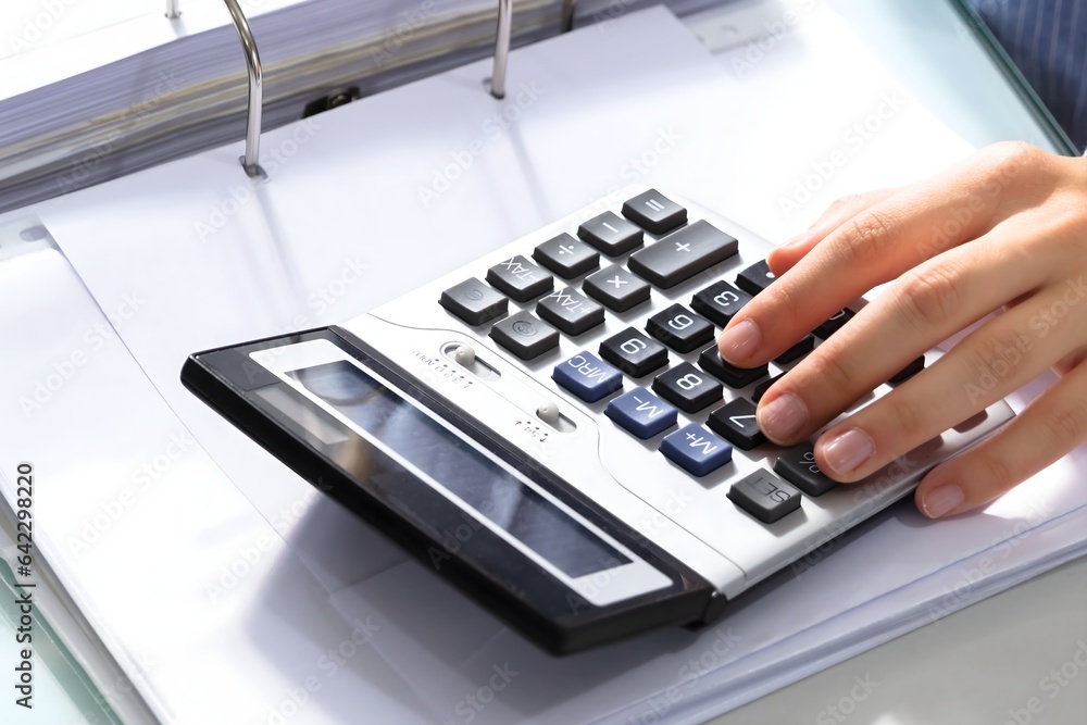 Poster businesswoman's hand calculating bill in office