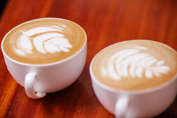 cup of cappuccino Grounded coffee beans hands sorting out red coffee maker machine equipment metal...