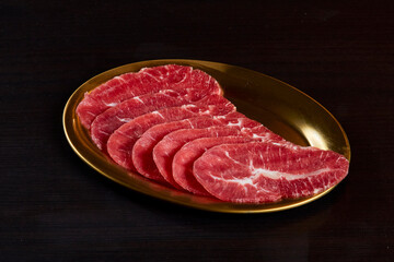 Beef raw sliced oyster blade, serve on gold stainless dish