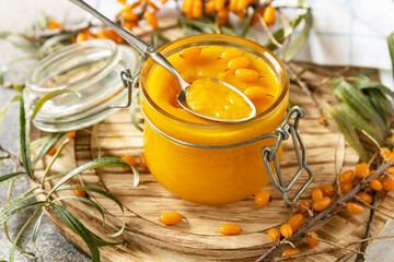 Homemade jelly, jam from a sea-buckthorn in glass jar of an organic sea-buckthorn on a stone...