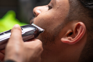 Barber Trimming Customer's Beard