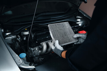 Car air conditioner system maintenance, Hand mechanic holding car air filter to check for clean dirty or fix repair heat have a problem or replace new or change filter.