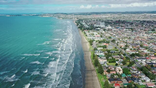 Aerial View from the Beach, Green Trees, City Streets, and Waves of Orewa in New Zealand - Auckland Area	