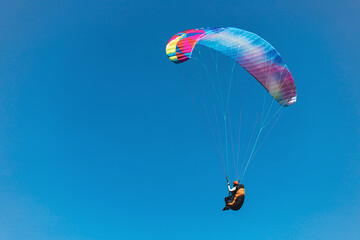 Paraglider in the sky. The sportsman flying on a paraglider.